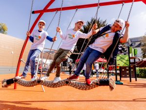 The boys happily on a swing in the comprehensive play area of Stück